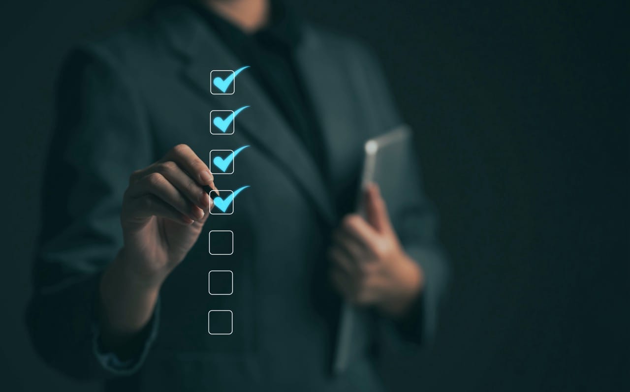 Business performance checklist concept Young business woman using laptop surveys online checklist Complete the digital form checklist via the internet..